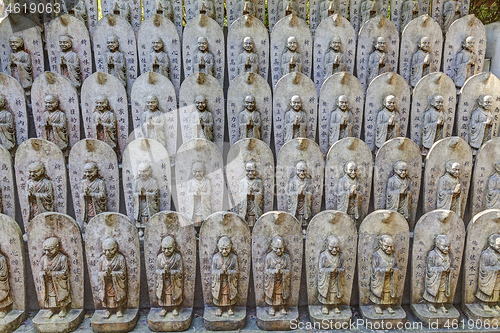 Image of Little stone statues near ancient japanese shrine