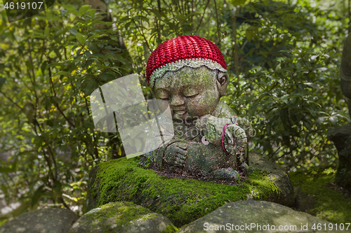 Image of Sheep - symbol of japanese horoscope. Jizo stone statue wearing knitted and cloth hats.