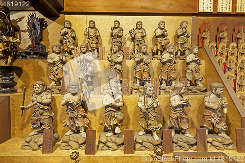 Image of Little wooden statues in ancient japanese shrine