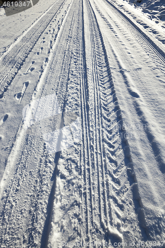 Image of trace of the car wheels on snow close-up