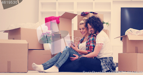 Image of young couple moving  in new house