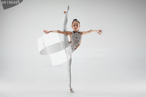 Image of The teenager girl doing gymnastics exercises isolated on white background