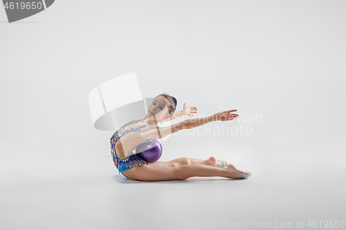 Image of The teenager girl doing gymnastics exercises isolated on white background