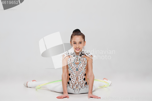 Image of The teenager girl doing gymnastics exercises isolated on white background