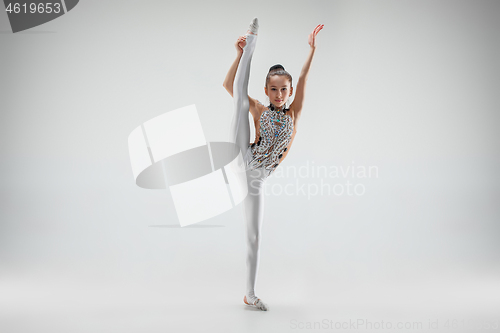 Image of The teenager girl doing gymnastics exercises isolated on white background