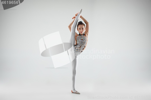 Image of The teenager girl doing gymnastics exercises isolated on white background