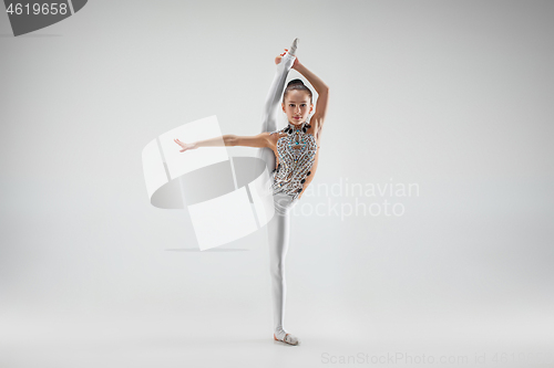 Image of The teenager girl doing gymnastics exercises isolated on white background