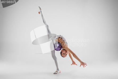 Image of The teenager girl doing gymnastics exercises isolated on white background