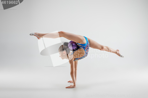 Image of The teenager girl doing gymnastics exercises isolated on white background