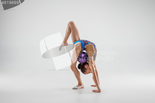 Image of The teenager girl doing gymnastics exercises isolated on white background