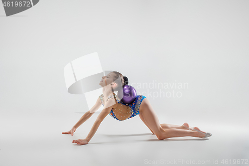 Image of The teenager girl doing gymnastics exercises isolated on white background