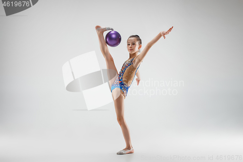 Image of The teenager girl doing gymnastics exercises isolated on white background