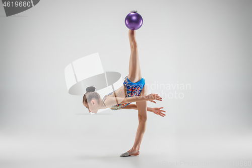 Image of The teenager girl doing gymnastics exercises isolated on white background