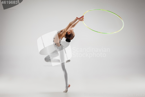 Image of The teenager girl doing gymnastics exercises isolated on white background