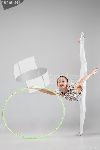 Image of The teenager girl doing gymnastics exercises isolated on white background