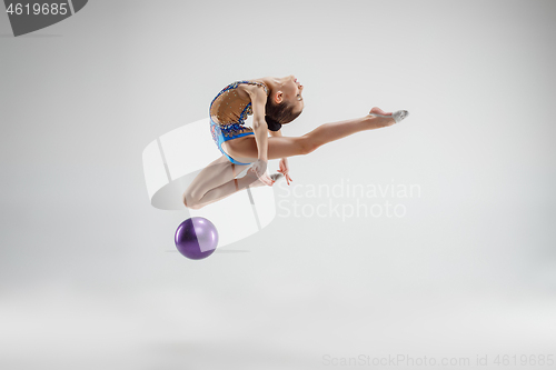 Image of The teenager girl doing gymnastics exercises isolated on white background