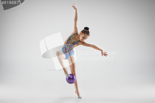 Image of The teenager girl doing gymnastics exercises isolated on white background