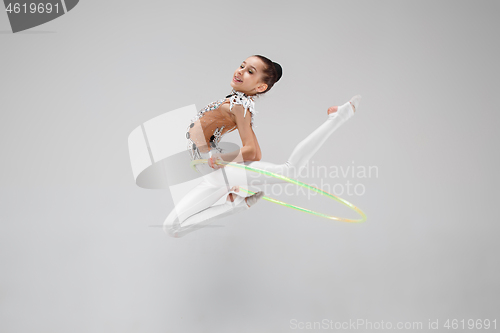 Image of The teenager girl doing gymnastics exercises isolated on white background