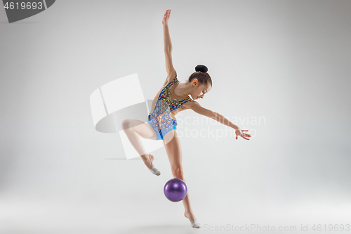 Image of The teenager girl doing gymnastics exercises isolated on white background