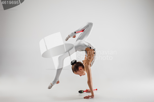 Image of The teenager girl doing gymnastics exercises isolated on white background