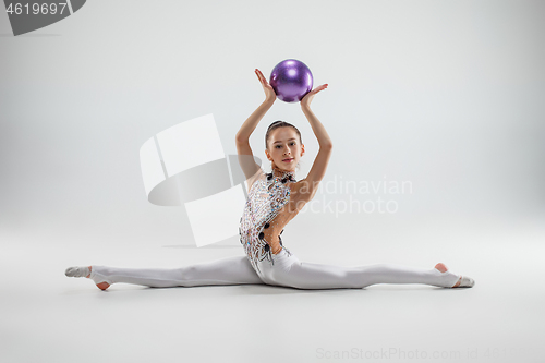 Image of The teenager girl doing gymnastics exercises isolated on white background