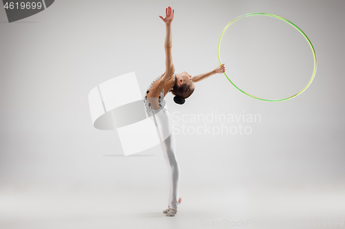 Image of The teenager girl doing gymnastics exercises isolated on white background