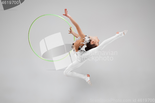 Image of The teenager girl doing gymnastics exercises isolated on white background