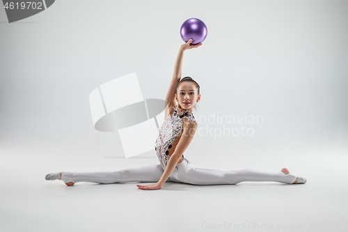 Image of The teenager girl doing gymnastics exercises isolated on white background