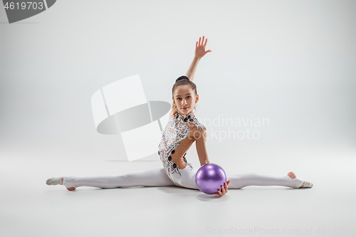 Image of The teenager girl doing gymnastics exercises isolated on white background