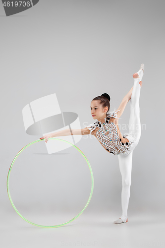 Image of The teenager girl doing gymnastics exercises isolated on white background