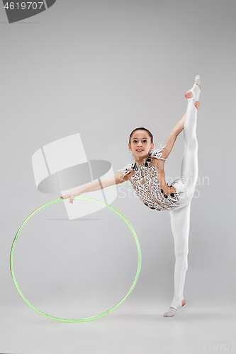 Image of The teenager girl doing gymnastics exercises isolated on white background