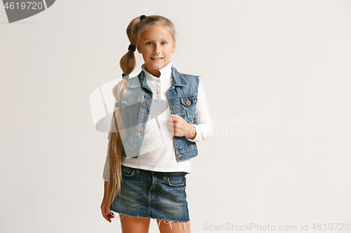 Image of portrait of cute little teen in stylish jeans clothes looking at camera and smiling