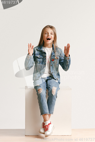Image of Full length portrait of cute little teen in stylish jeans clothes looking at camera and smiling