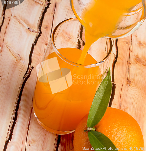 Image of Pouring Orange Juice Means Tropical Fruit And Refresh 
