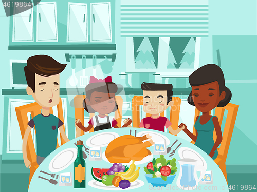 Image of Multiracial family praying at festive table.