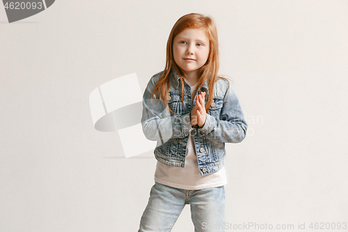 Image of portrait of cute little kid in stylish jeans clothes looking at camera and smiling