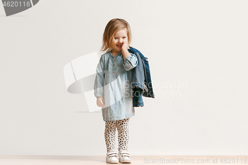 Image of Full length portrait of cute little kid in stylish jeans clothes looking at camera and smiling