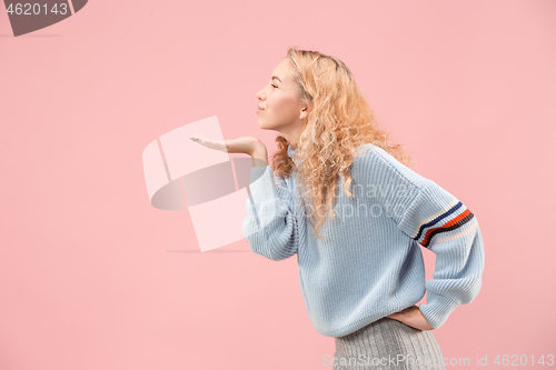 Image of Portrait of attractive cute girl with bright makeup with kiss isolated over pink background