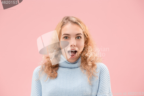 Image of Beautiful woman looking suprised isolated on pink