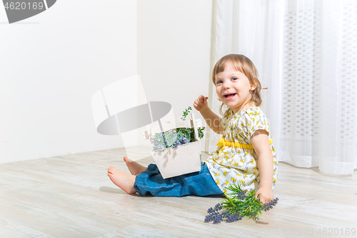 Image of Cute girl with spring flowers