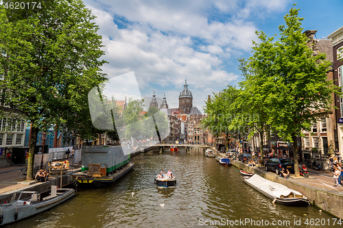 Image of Canal and St. Nicolas Church in Amsterdam