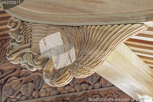 Image of Wooden carving of crane decorates the gable of a roof over the entrance of an ancient Buddhist temple in Japan.