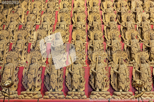 Image of Little wooden statues in ancient japanese shrine