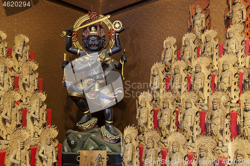 Image of Little wooden statues in ancient japanese shrine