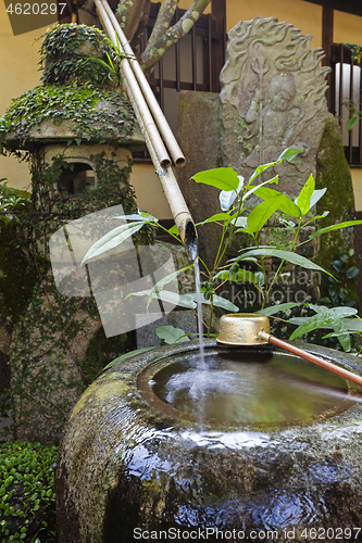 Image of Traditional japanese bamboo purification fountain for purification at entrance of the Japanese temple.