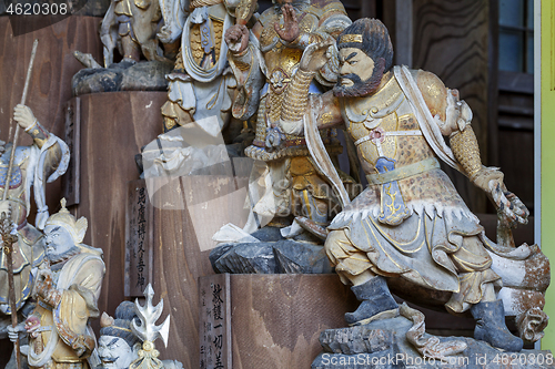 Image of Little wooden statues in ancient japanese shrine