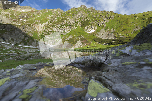 Image of Alpine lake under Pietrosul mountain in Romania