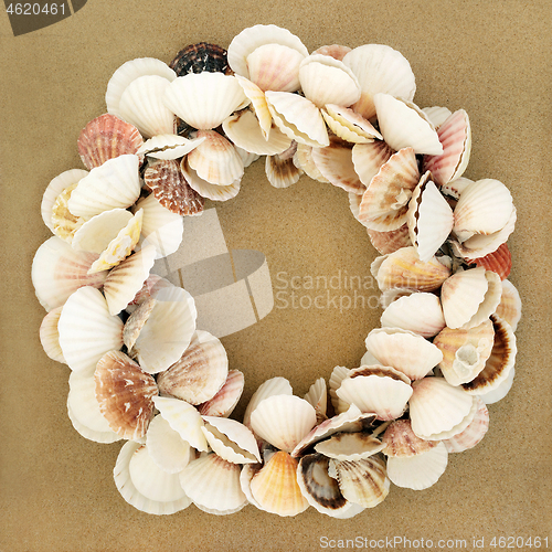 Image of Scallop Shell Wreath on Beach Sand 