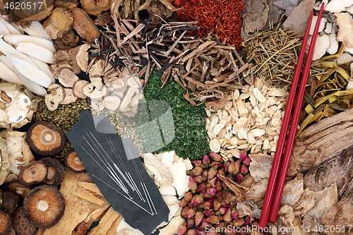 Image of Chinese Herbal Medicine with Acupuncture Needles