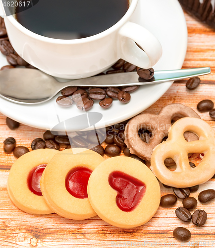 Image of Mug of freshly brewed coffee and heart cookies 